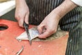 British fish monger fillets a dover sole and pulls itÃ¢â¬â¢s skin a Royalty Free Stock Photo